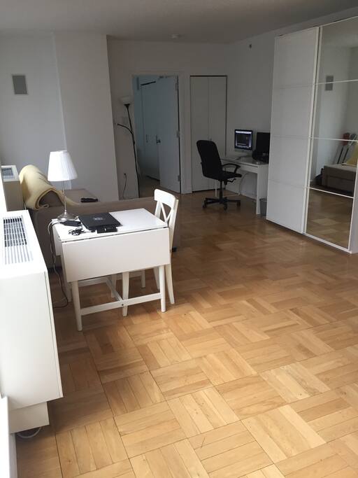 Living room with kitchen table that seats four, pull out sofa sleeps two, lots of closet space, desk with wifi and cable tv