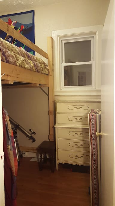 In order to get into the loft bed, you must climb up wooden pegs - shown to the left of the dresser. The stool shown makes it easier to begin the ascent!