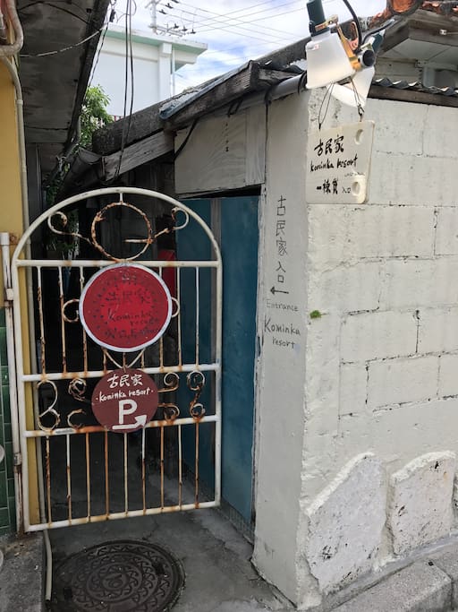 入り口。この赤い看板の扉の奥。鍵は暗証番号を入力してご自分で開けてください。