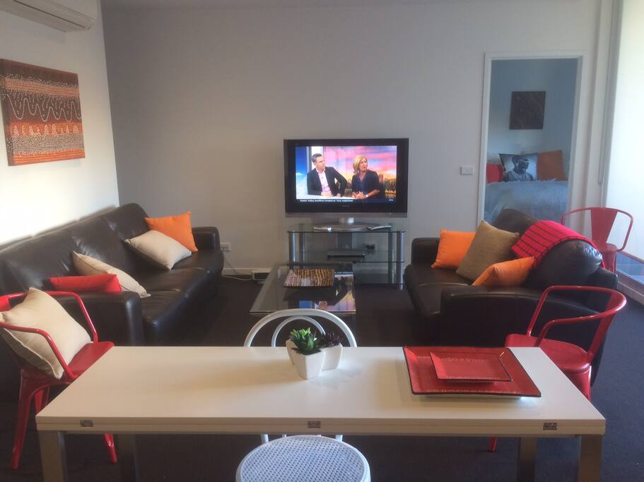 Lounge room with large balcony with City views to the right