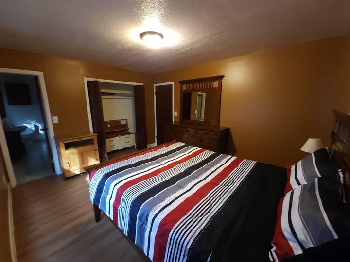 Cama queen y vestidor con espejo.