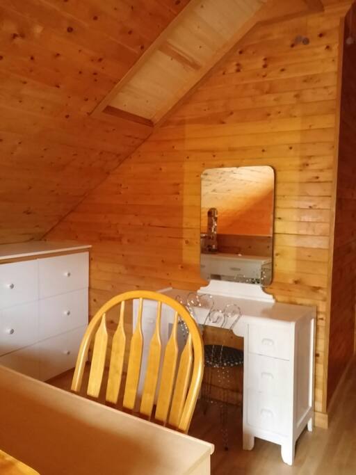 Upstairs loft with vanity and desk.