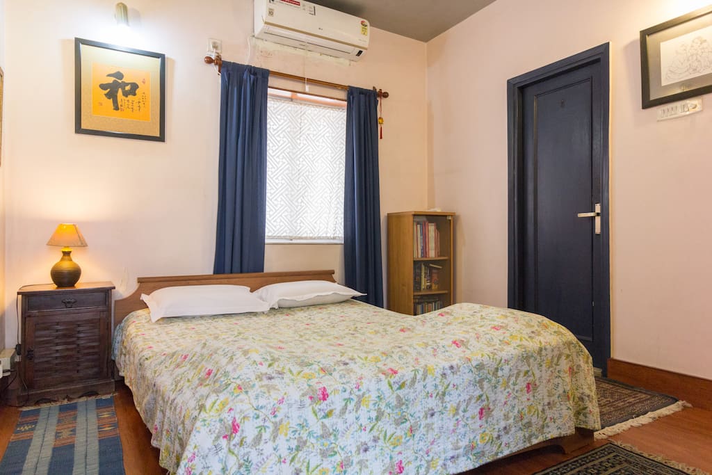 Another view of the master en-suite bedroom - wooden floors, Kashmiri handwoven carpets, 300 TC bed linen, memory foam pillows, original contemporary Indian and foreign art and hand embroidered kantha eiderdowns!