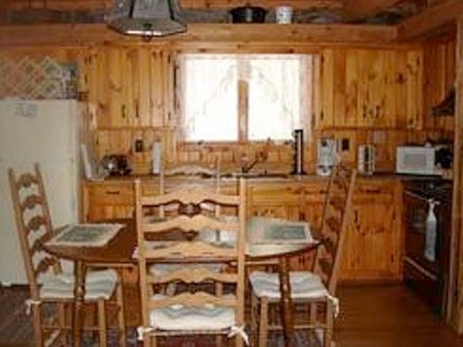 View of Kitchen with open floor plan. Beautiful post and beams give rustic charm.