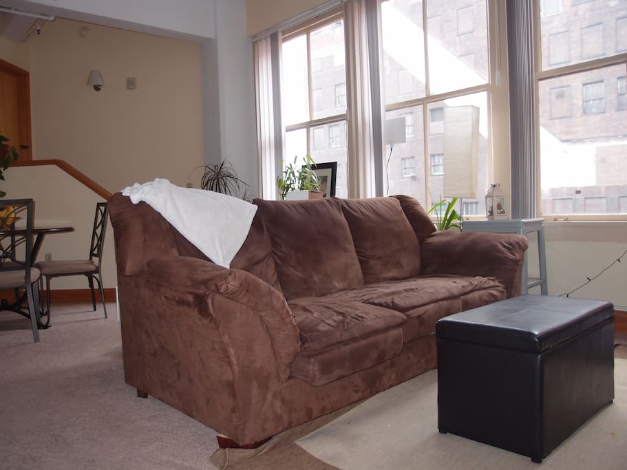 Comfortable couch with views of Tower City. Faces TV with Blu-ray player.