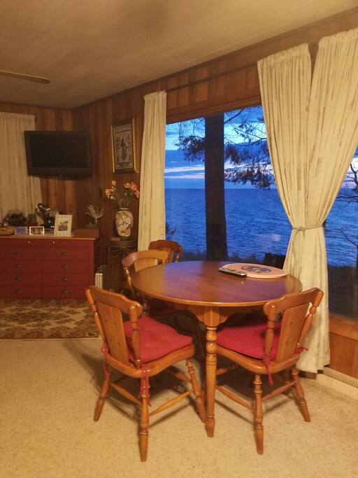 Living room where you can look at the Lake. Notice TV on the wall