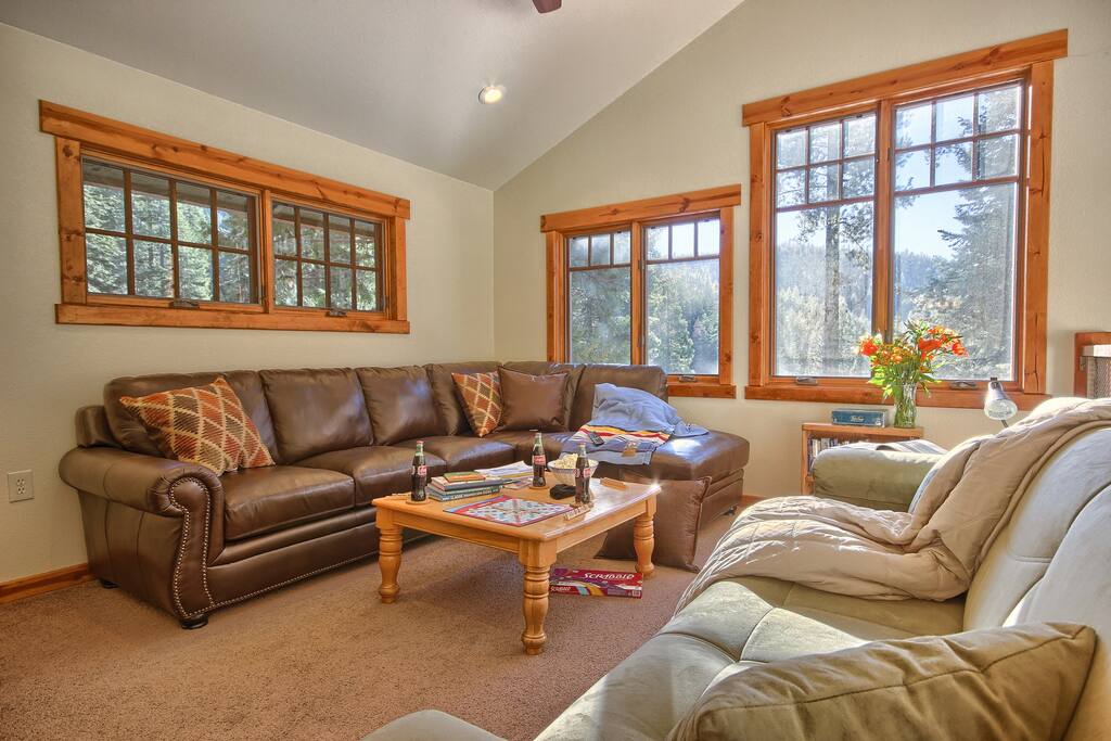 Loft TV area. Forest shines in to comfy space. Books, games and video library.