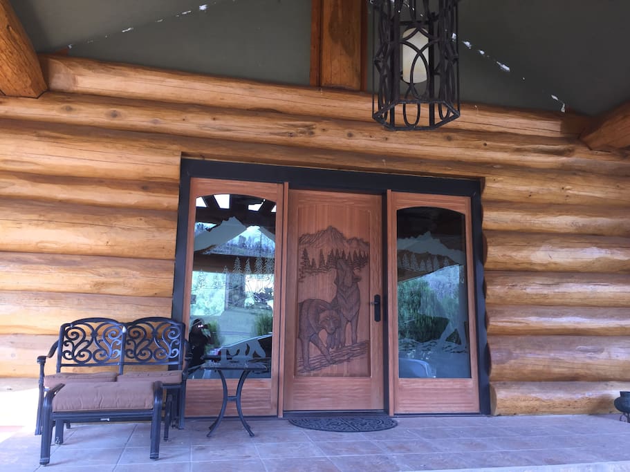 Front entry door with wolf carvings.Enter and feel the warmth of our home.