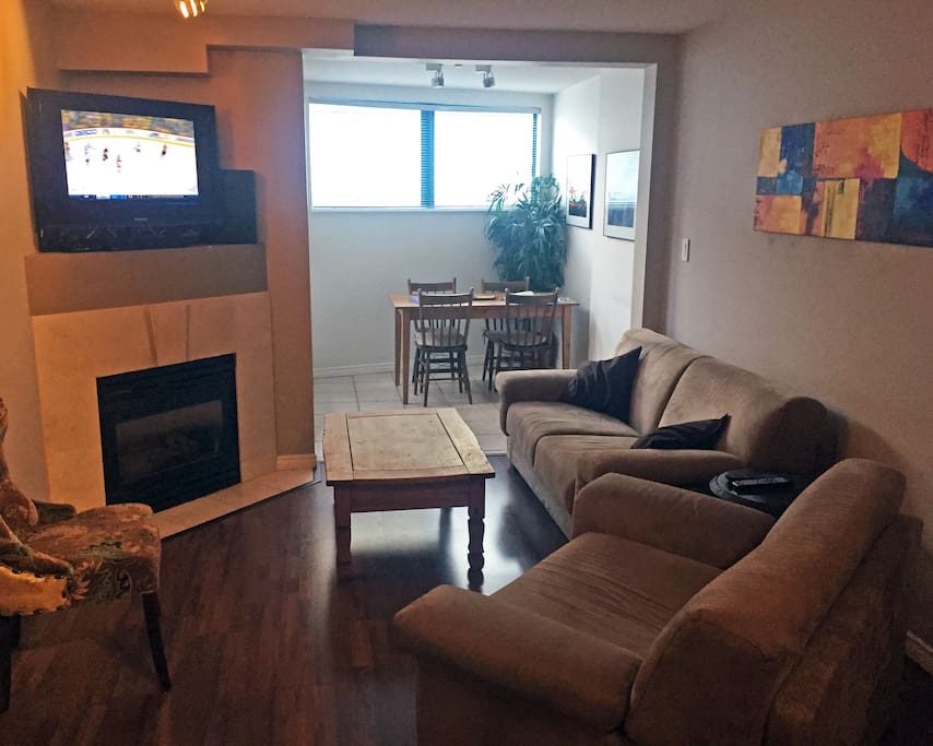 Open plan layout with cozy fireplace and large patio