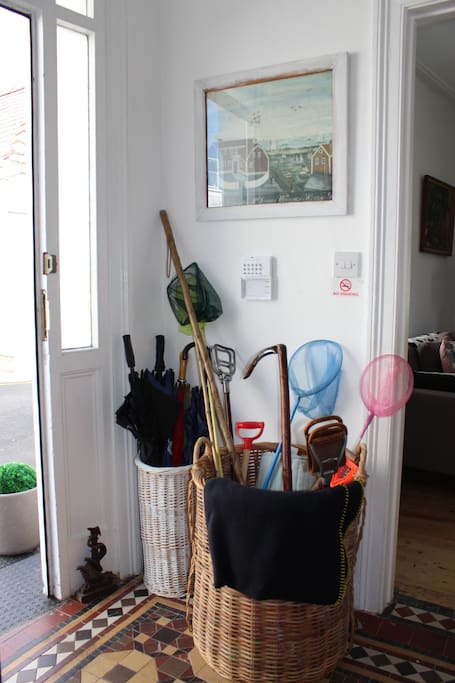 Baskets of walking sticks, umbrellas, fishing nets and more at the front door.