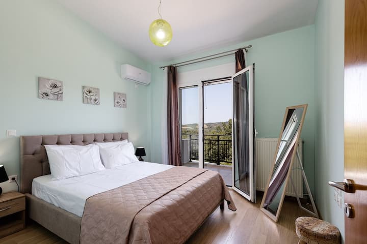 1st Floor | Bedroom 3 | A SMART TV 32" with a seamless connection to a balcony offering picturesque views of the charming village.