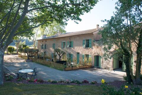 Gite overlooking Canal du Midi amid vineyards.