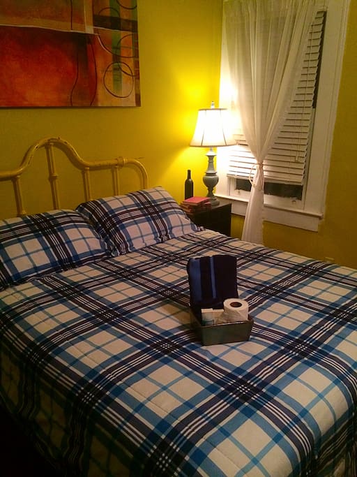 Queen size bed in a large room.