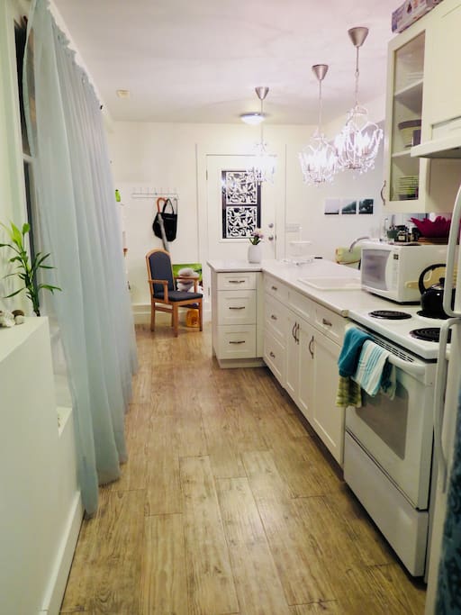 From the bedroom looking through the kitchen to the private entrance