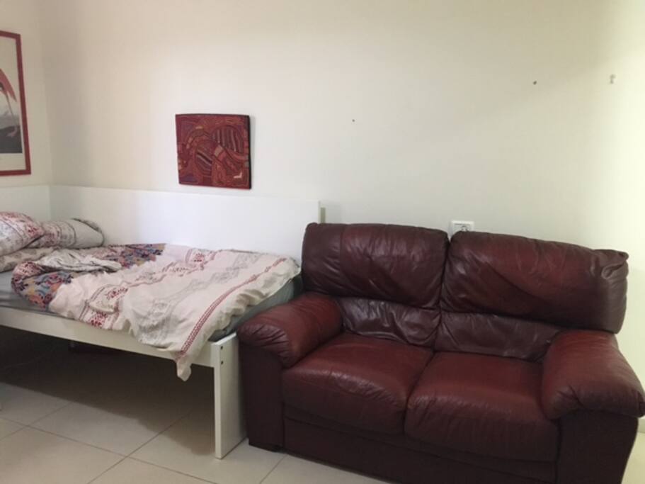 A small leather couch for comfortable seating.