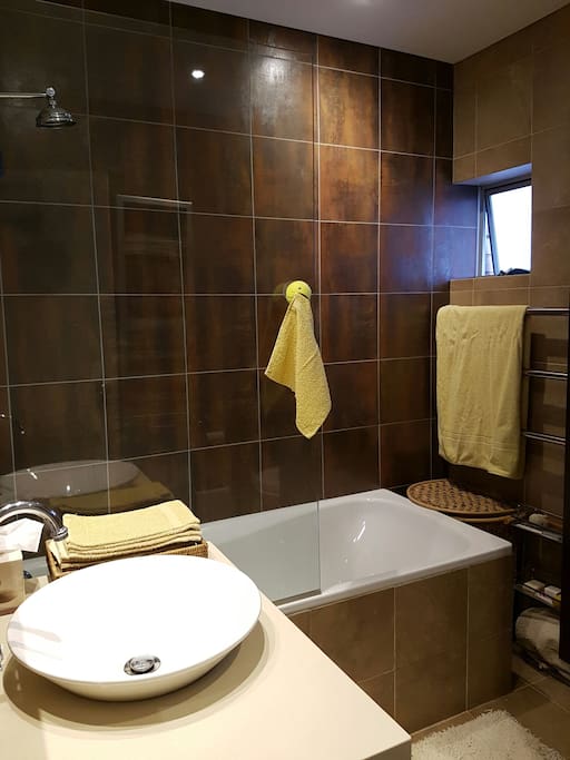 Bathroom with shower over bath, towels provided