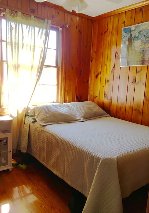 Comfortable, full size bed. Shelving and closet for clothes and storage. Also a bedside table with lamp.
