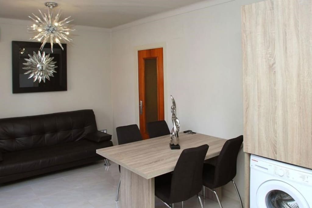 The lovely living room includes a comfy sofa and a dining area.