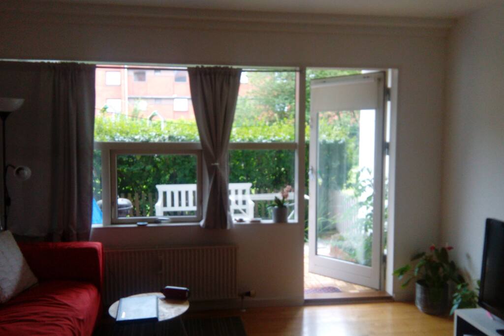 Open plan living room with adjoining private garden