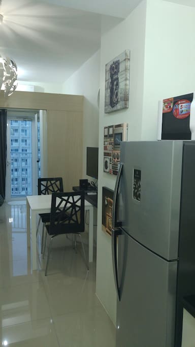 microwave oven on top of fridge