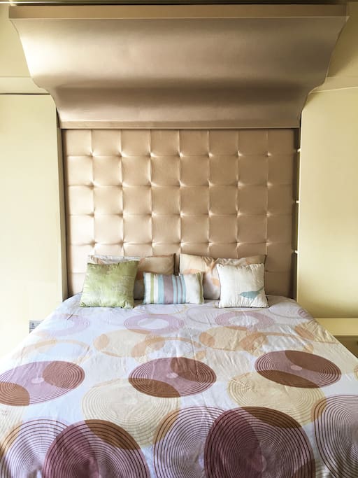 Full King Sized Bed with Padded Upholstered Tufted Rose Gold Synthetic Leather.