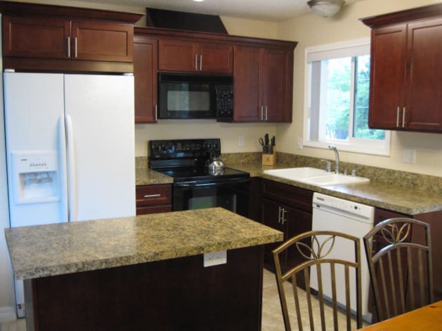 Nicely remodeled kitchen with Cherry cabinets... all cookware and dishware included.