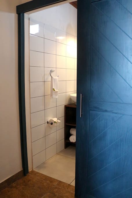 Barn door leading to private bathroom