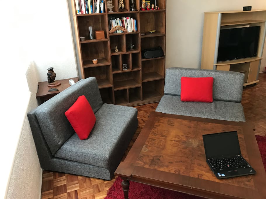 This is the living room, a comfortable space with three couches, all of them turn into beds.