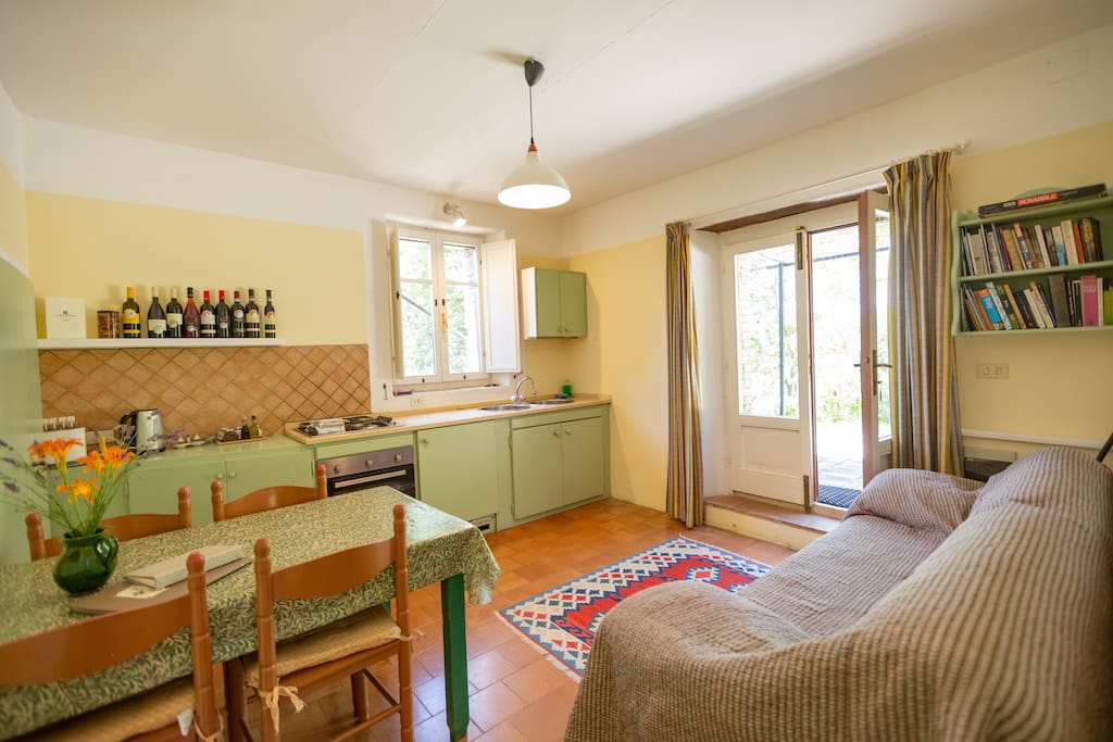 Living room with sofa, dining table and four chairs, china cupboard, Wi-Fi access. Kitchen area with fitted cupboards and marble work surface, inset gas hob, sink, built-in fridge/freezer, oven with grill, microwave, iron and ironing board.