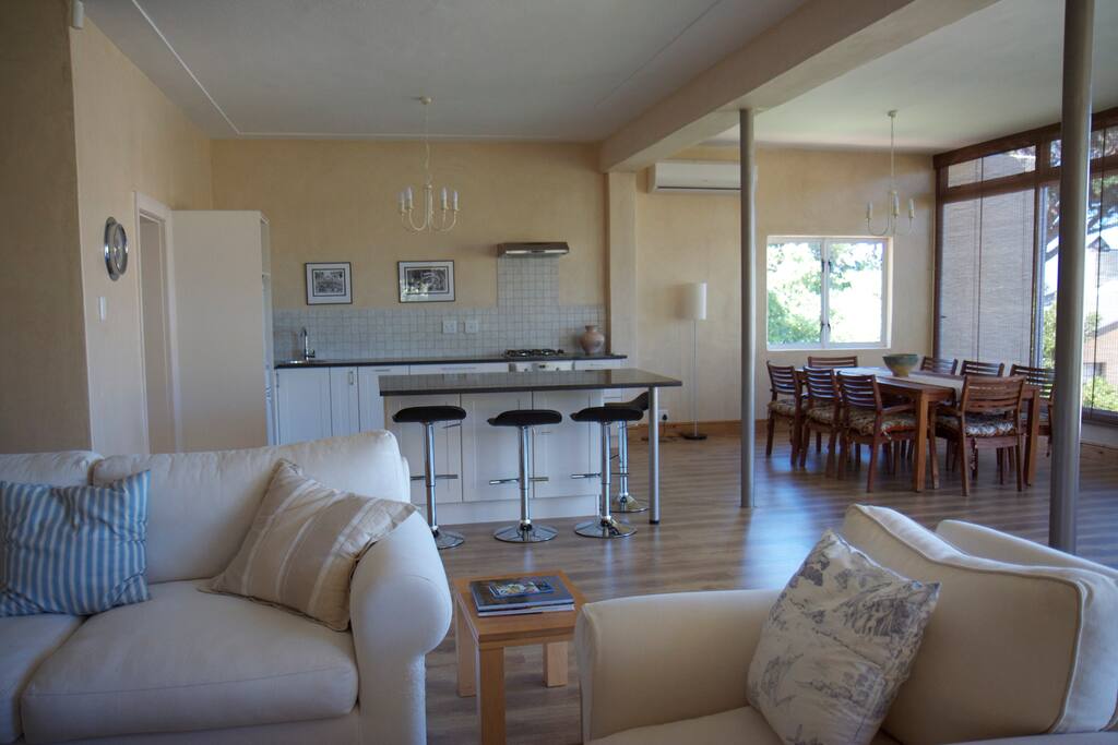 Looking towards the open plan kitchen - settee and chair face a wood burning fire place