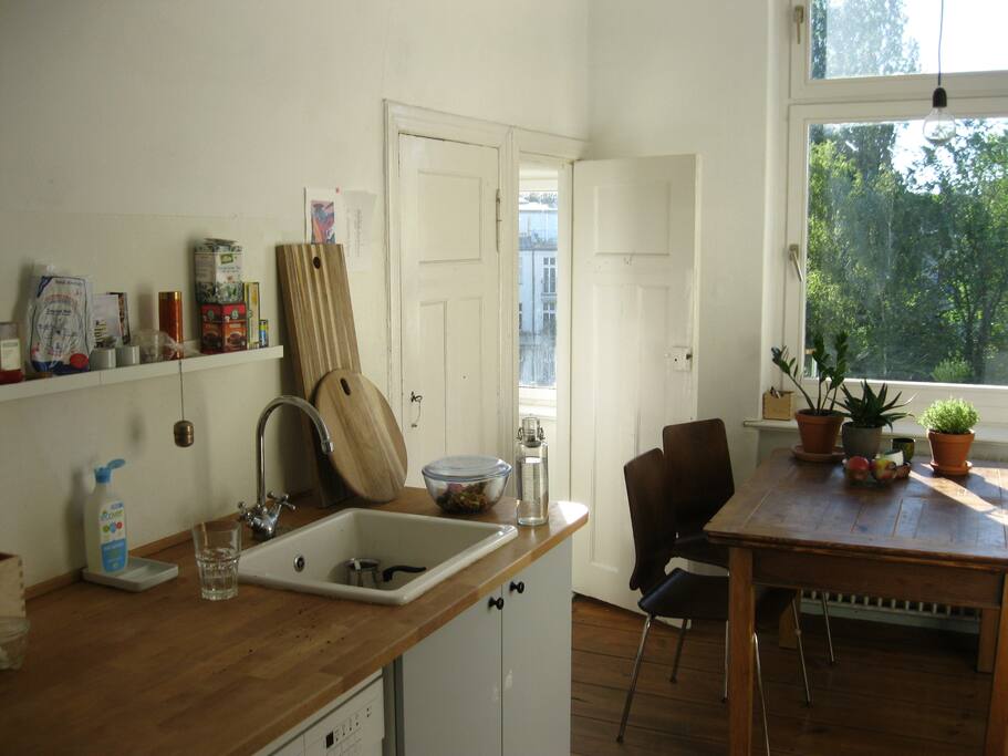 the kitchen with the door leading to the small bedroom