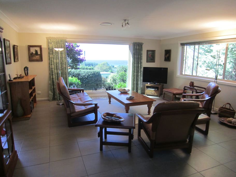 Lounge area with large picture window overlooking the front garden and sea .