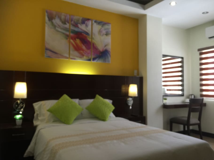 Air conditioned room with queen size bed, bathroom and TV set