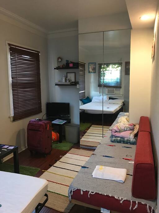 Full-length couch in bedroom.