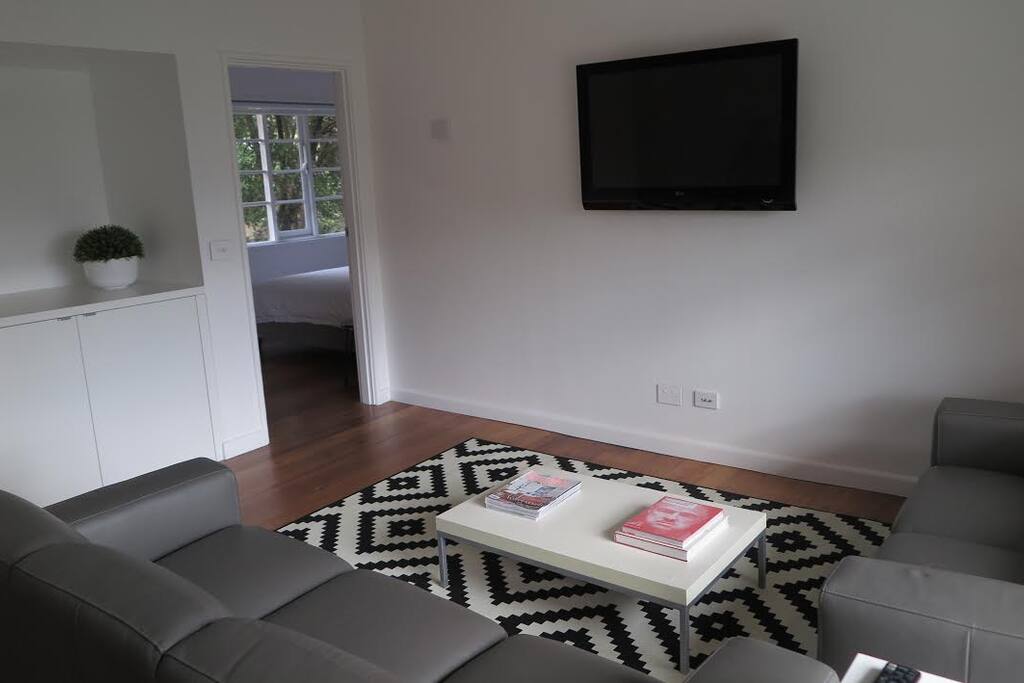 Spacious living room with 2 leather sofas