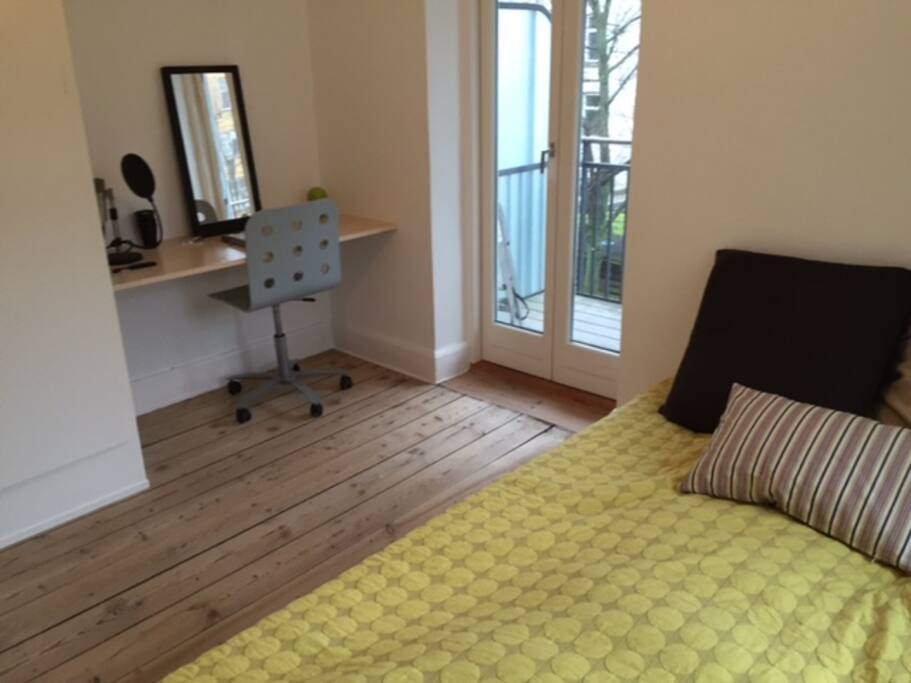 The bedroom has a desk