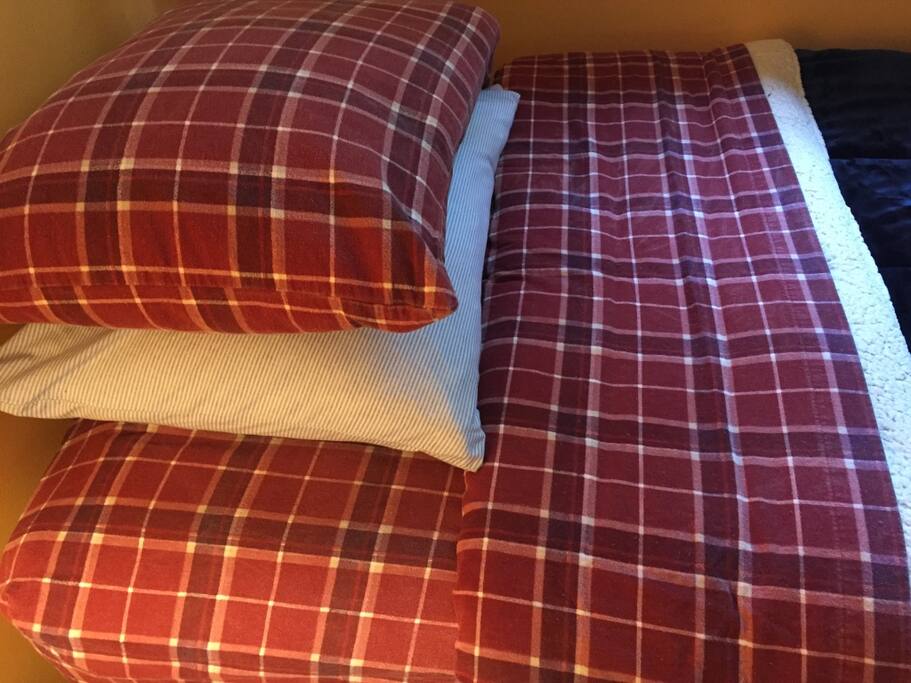 Flannel or plush red fleece sheets with new sherpa comforters... mattresses are firm with a soft mattress cover.