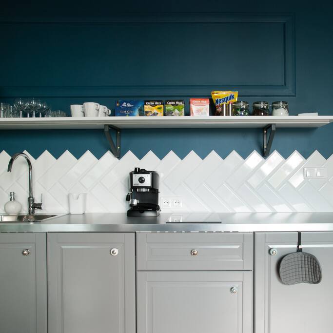 Kitchen with cooking equipment and coffee machine