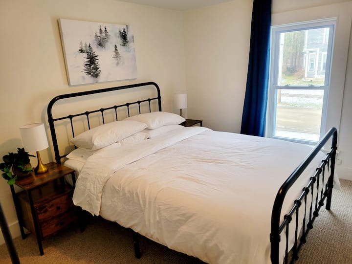 Second bedroom with queen bed, side tables and lamps, usb plugs, room darkening curtains and space to put away your things.