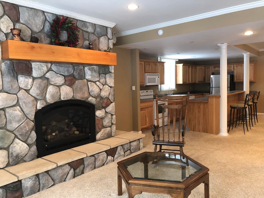 River-stone gas fireplace with view to the woodland, great for a romantic evening.