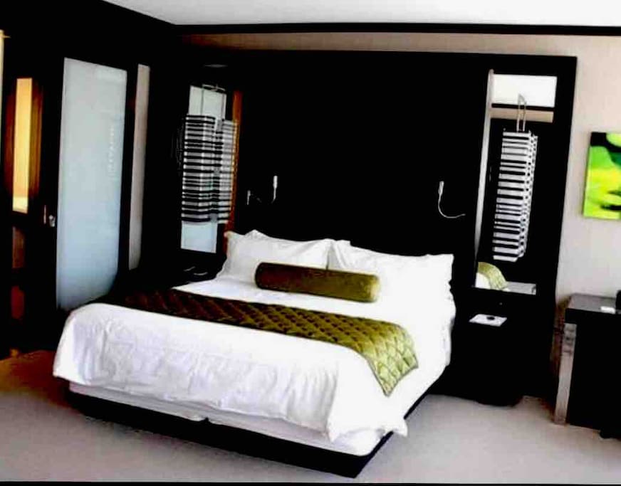 King size bed, soft high quality linens, charging outlets on both nightstands, his and her reading lights
