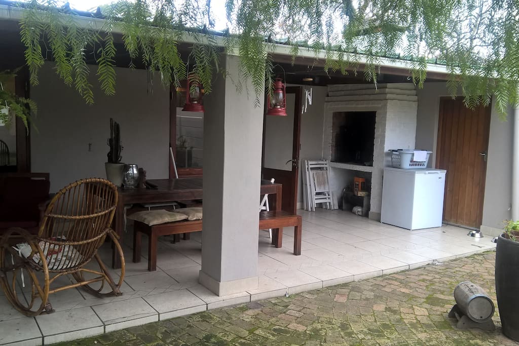 The patio and outside eating area. Washing machine for guest use in the utility room to the right.
