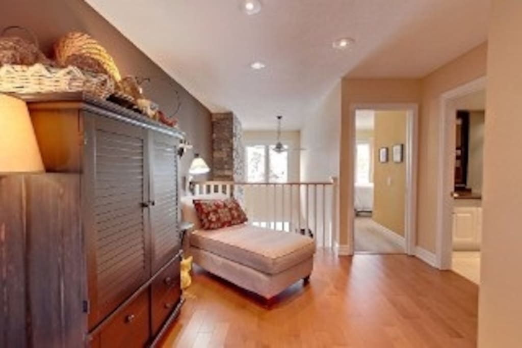 Relax on this chaise lounger while reading a book . Located on 2nd floor outside master bedroom
