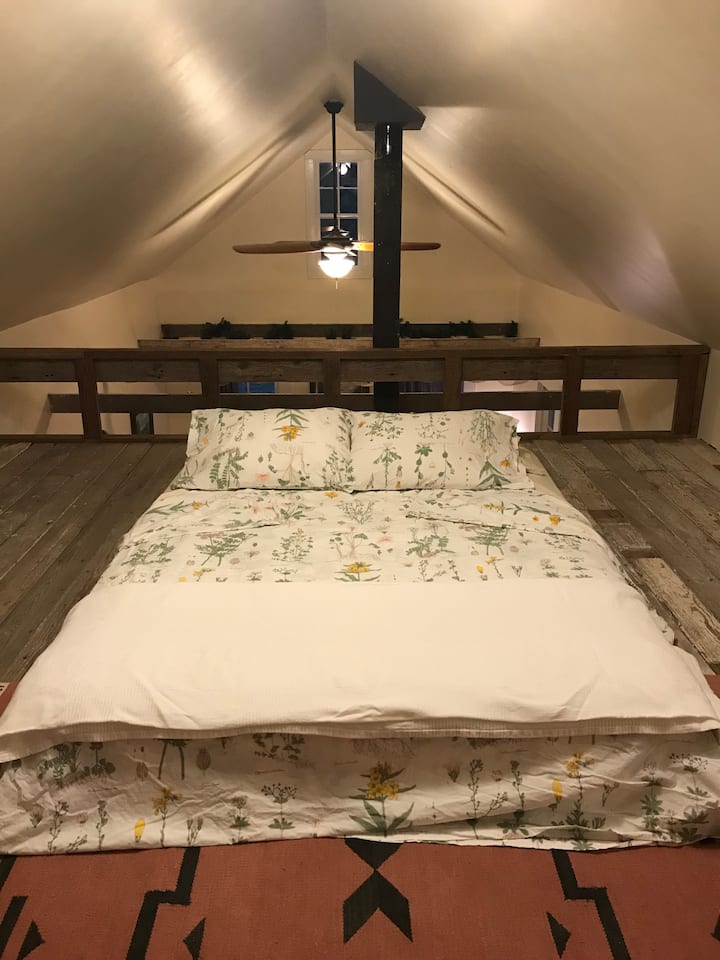 Queen bed upstairs in loft.