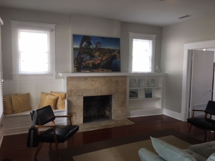 Enjoy the warm and inviting living room with the travertine fireplace, built in reading benches and dark hardwood floors