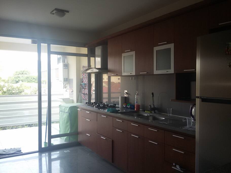 Cocina con balcón y vista a la colina
