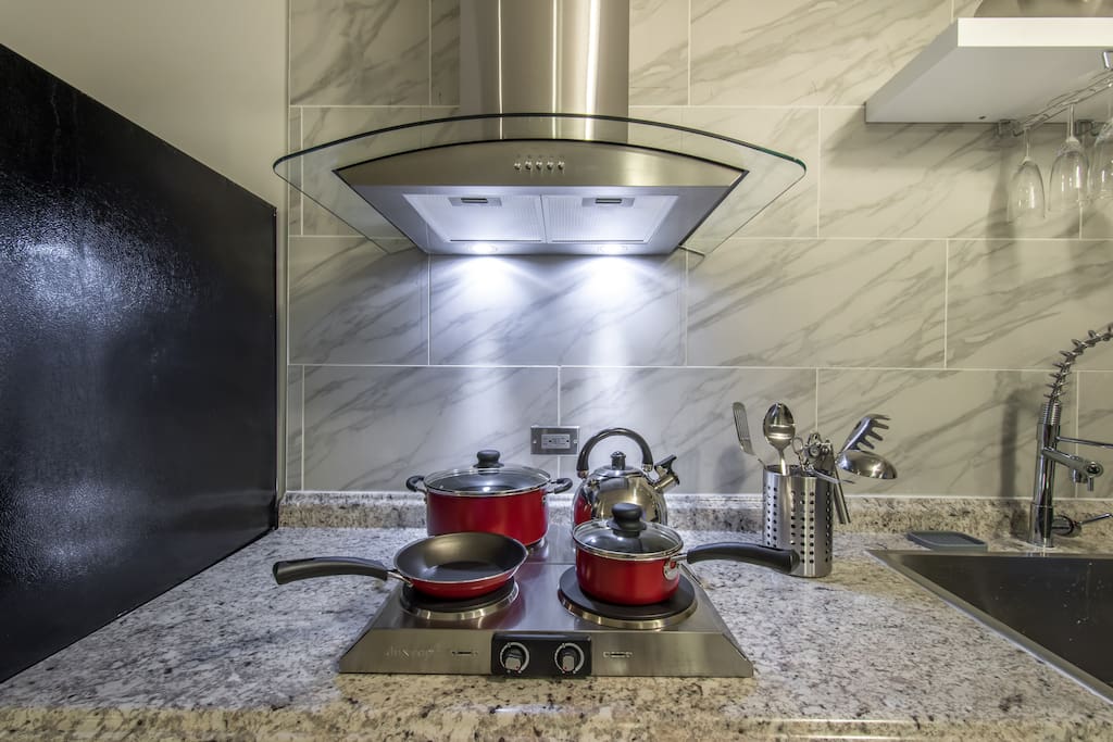 Newly remodeled kitchen with stainless steel appliances, stocked with all supplies needed for a home-cooked meal