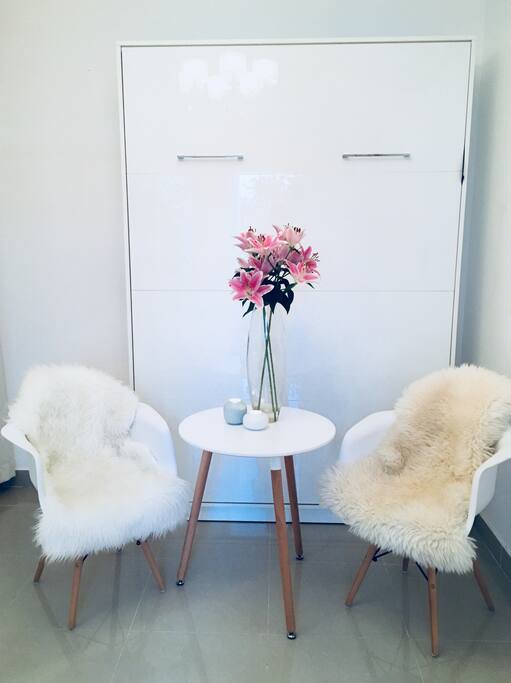 Nice sitting area in front of the wardrobe bed