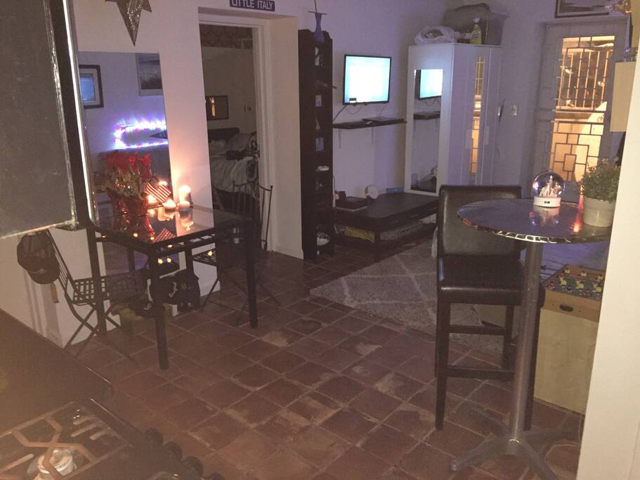 Broader shot of living room with back yard door set on the right master bedroom on the left kitchen is right behind photographer here in this picture