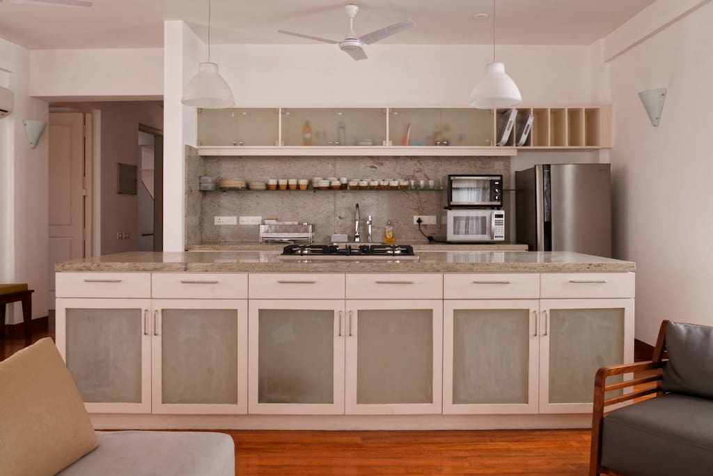 Modern Kitchen with microwave and toaster over - high end Kichen pots and pans